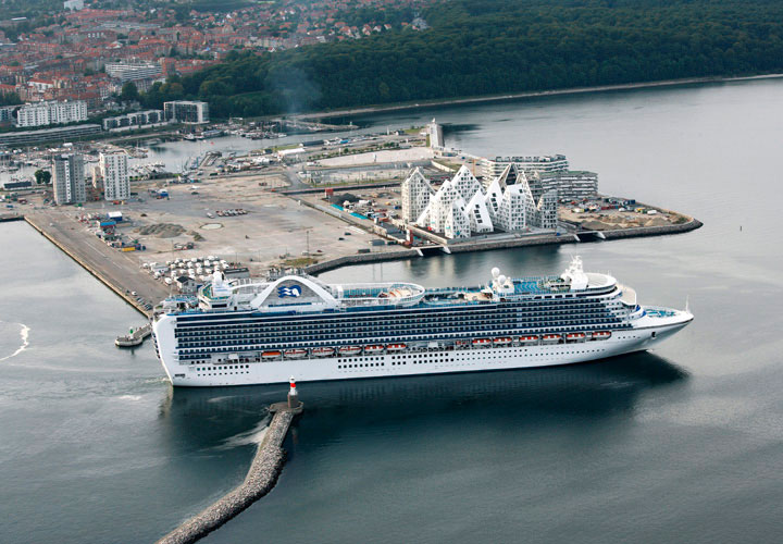 Aerial view of the Iceberg Aarhus building by CEBRA architecture next to a cruise ship.