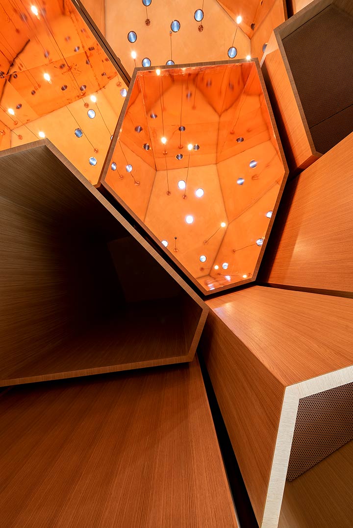 Al Musallah prayer hall in Abu Dhabi designed by CEBRA Architecture. Small openings are combined with pendant lights. 
